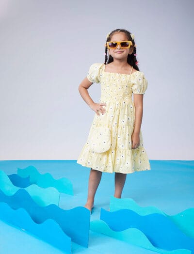 Three tiered sleeveless dress with long bow at waist